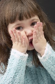 Small girl with hands to her face