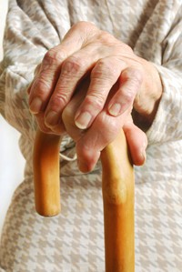 elderly woman's hands on walking stick